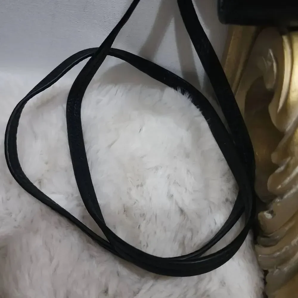 Coach Avery leather phone crossbody w/ a flap closure.